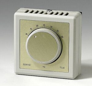 Sunvic TLM2802 room thermostat in white plastic casing with large rotary temperature control dial marked in degrees Celsius and clear on/off indicator line.